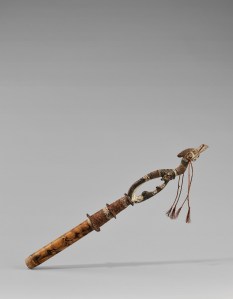 Tube à chaux et son bouchon, Iatmul, cours moyen du fleuve Sepik. Ce tube où l’on conservait la chaux associée à la mastication de la noix de bétel est constitué, dans sa partie inférieure, d’un embout en fibre végétale tressée faisant office de bouchon. Ce dernier est prolongé d’une figure ornementale composite combinant un corps d’oiseau surmontant une tête de crocodile, êtres mythiques fondateurs du clan propriétaire de l’objet. L’autre extrémité du tube est ornée de motifs abstraits pyrogravés. Ces objets, portés sous le bras, le bouchon vers le bas, faisaient partie des ustensiles de prestige qui étaient remis aux jeunes hommes à la fin de leur cycle d’initiation. Consommé au cours des rites et des cérémonies, le bétel accompagnait également tous les gestes de la journée. Bois, chaume de bambou, rotin, fibre, pigments et chaux. L. : 63,4 cm. Offert aux MRAH par la baronne de Béthune-Wienholt. Acquis des MRAH par voie d’échange en 1979. © MRAC. Inv. EO.1979.1.1308.